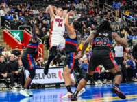 Miami Heat guard Tyler Herro (14) passes the ball against the Detroit Pistons defense during the second half at Little Caesars Arena in Detroit, Tuesday, Nov. 12, 2024.